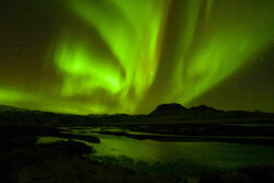 Evolving green aurora formation over river delta and hill formation 15 dsc 1017