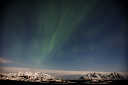 faint aurora arc over distant snow covered mountains/islands with full moon 5 dsc 2602