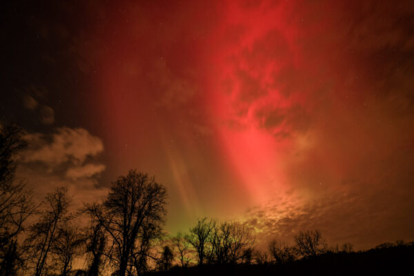 Rare intense solar storm sends intense aurora display well to the south, intense red ray streams through the clouds newjersey